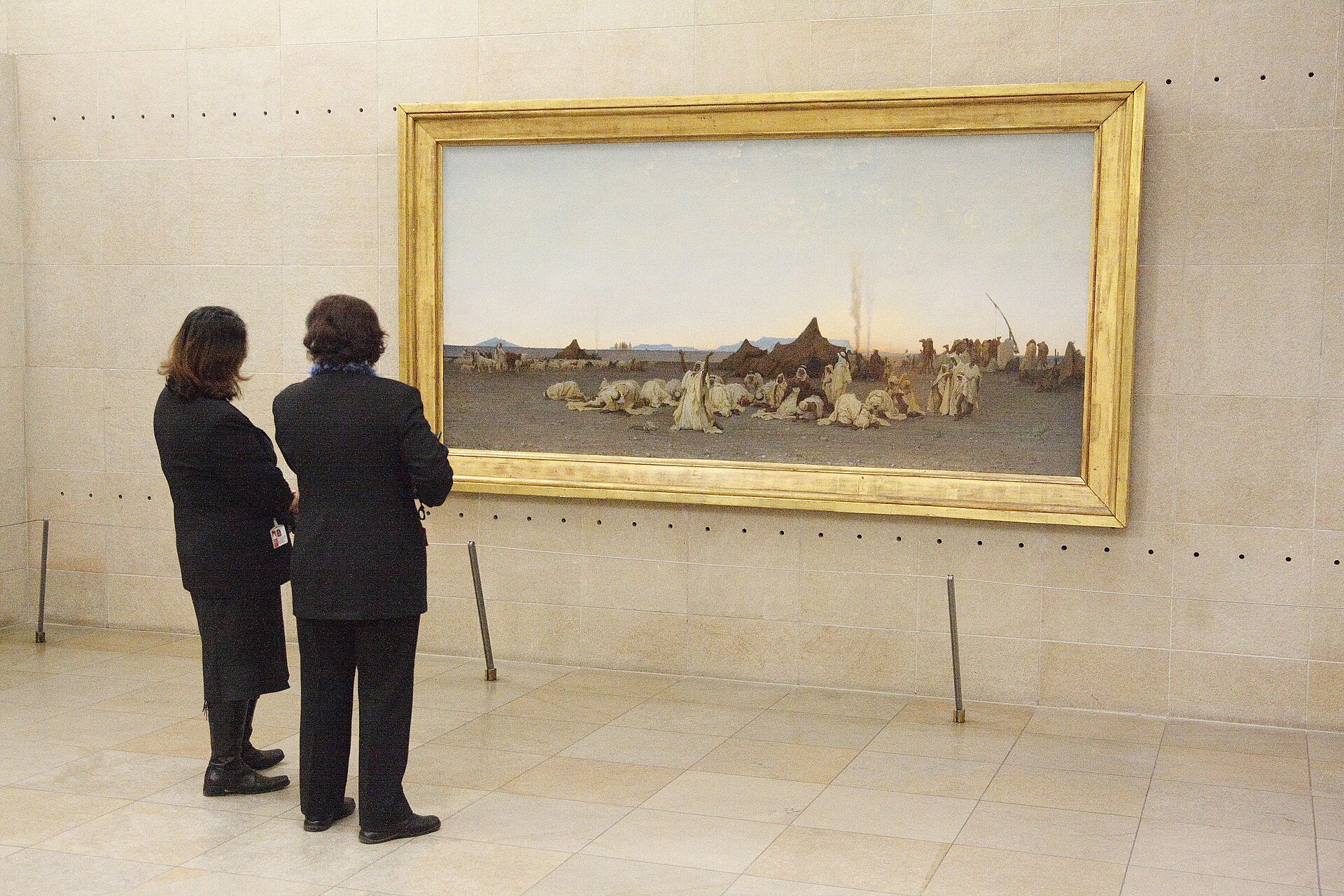 30 Free Things to Do in Paris 15 Two visitors standing in front of a painting at the Musee d'Orsay in Paris