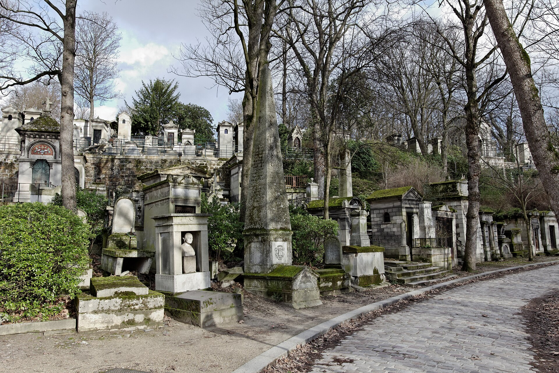 30 Free Things to Do in Paris 19 Crowded tombs along a cobbled path in Pere Lachaise cemetery in Paris