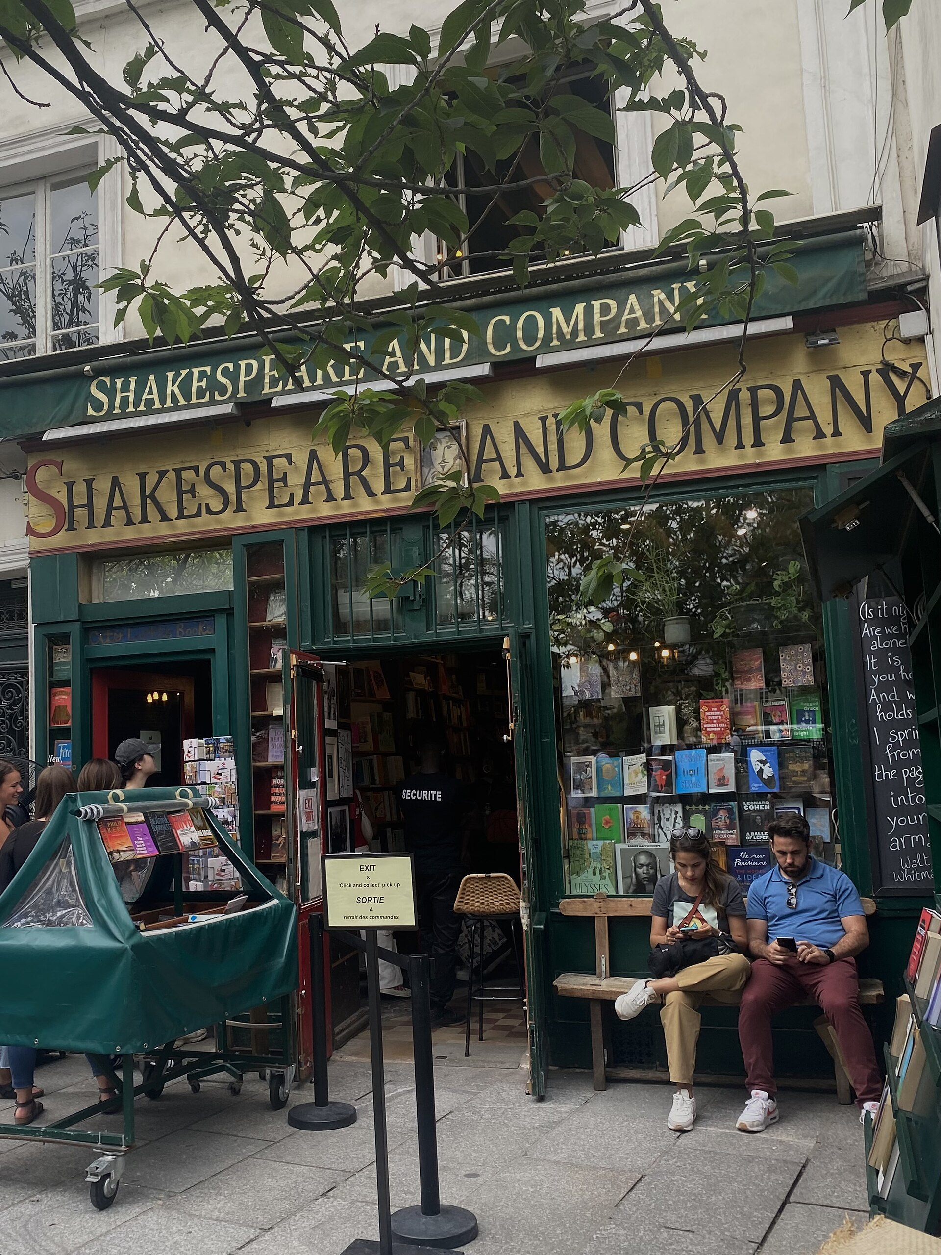 30 Free Things to Do in Paris 28 The green storefront and hanging sign of the Shakespeare and Company bookstore near Notre-Dame in Paris