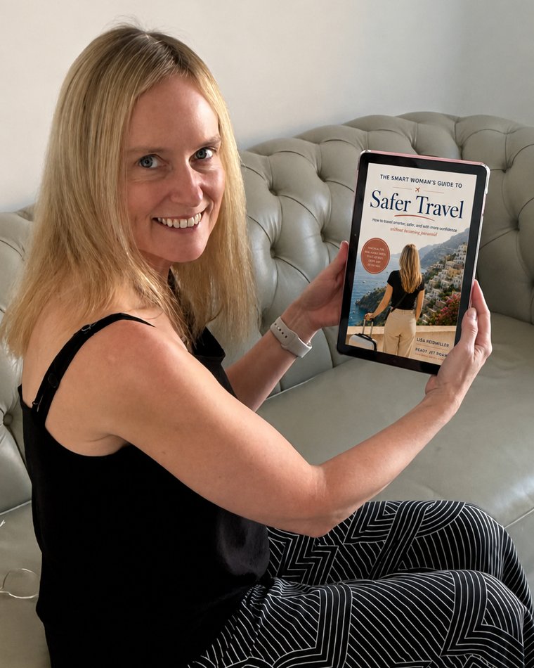 Lisa Reidmiller holding the Safer Travel guide on an e-reader